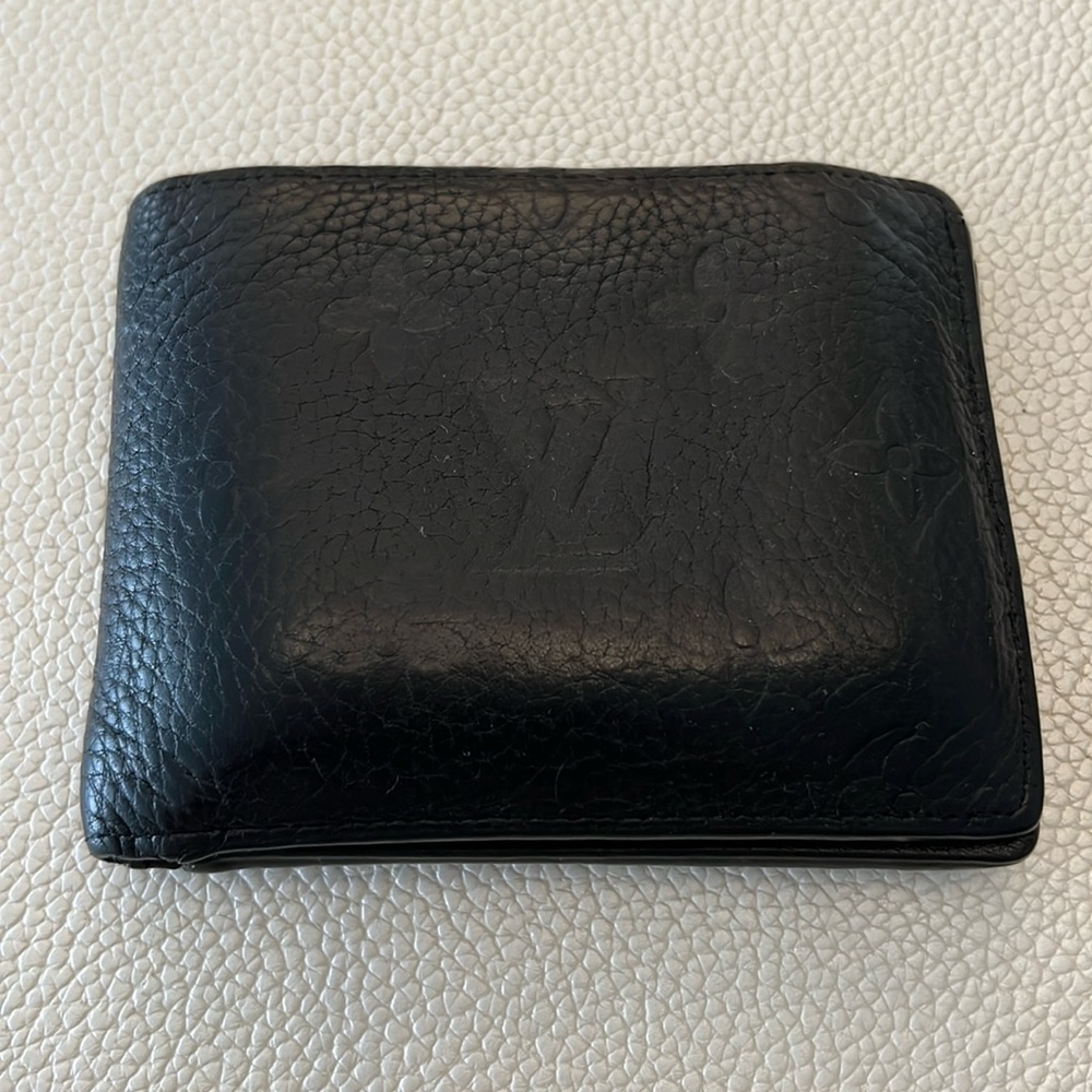 Full-grained Taurillon leather with Monogram Flowers and LVs embossed.
